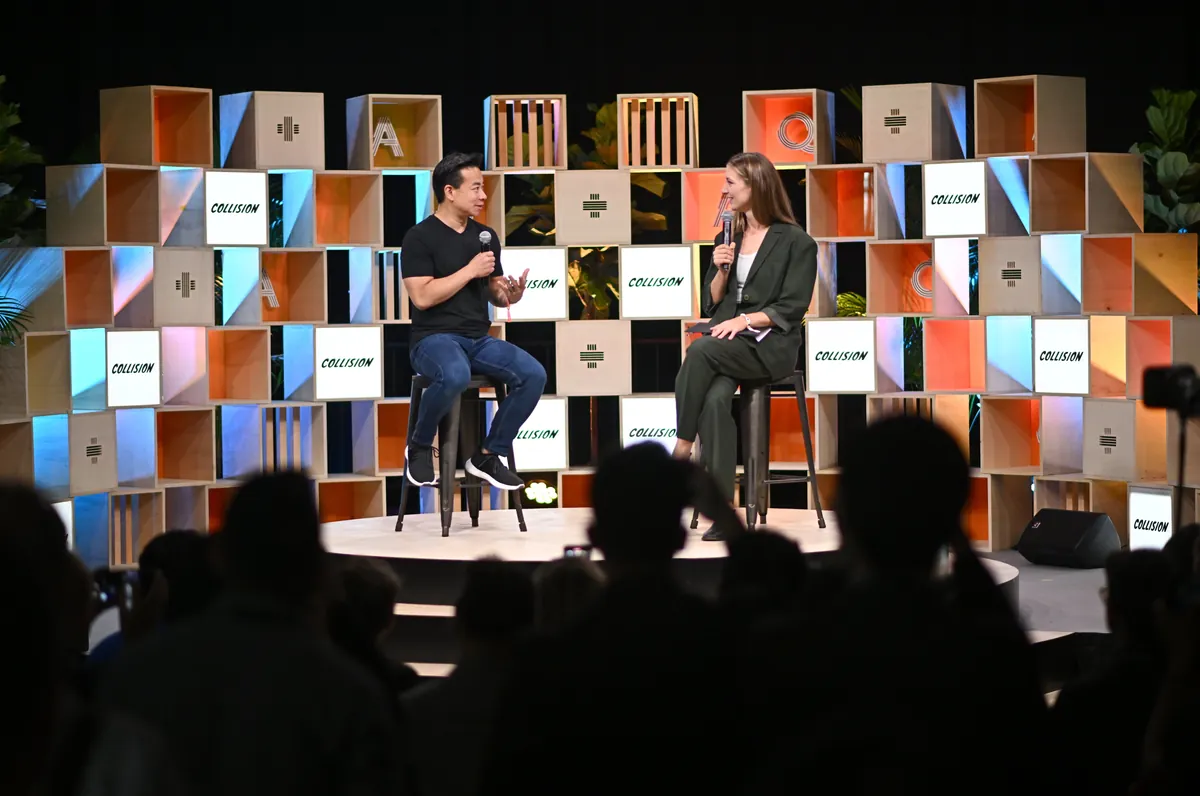 Ken Sim answers questions on stage at Collision 2023 in front of an audience.